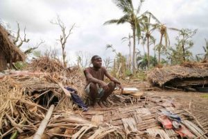 Masau Kinia sits on the rubble of his home on Tanna island